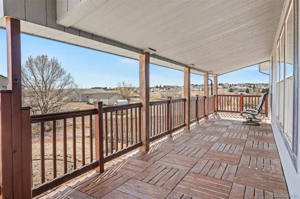 a view of a balcony with wooden floor