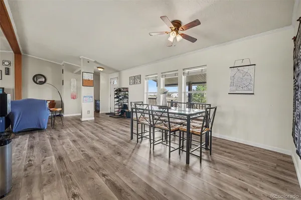 a view of a dining room with furniture and wooden floor