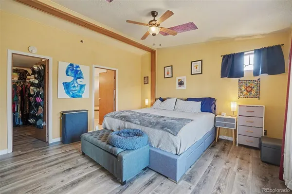 a spacious bedroom with a bed and a chandelier