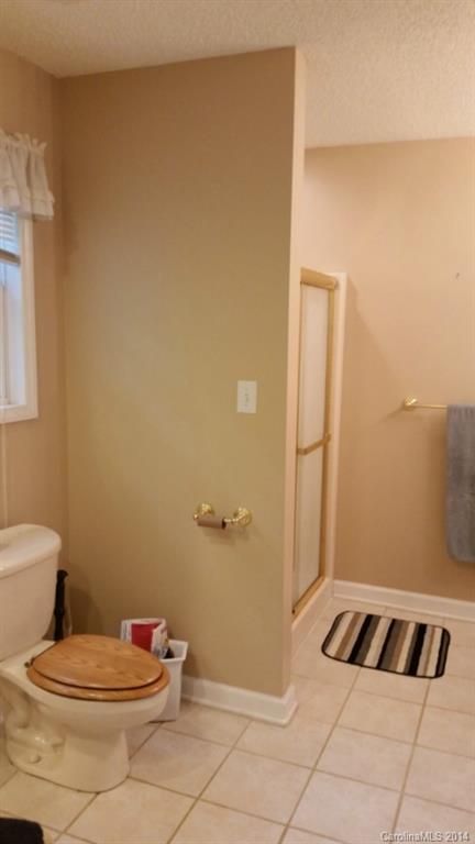 7003 Providence Road South Waxhaw, NC 28173 - Photo 14 of 20 a bathroom with a toilet and a shower
