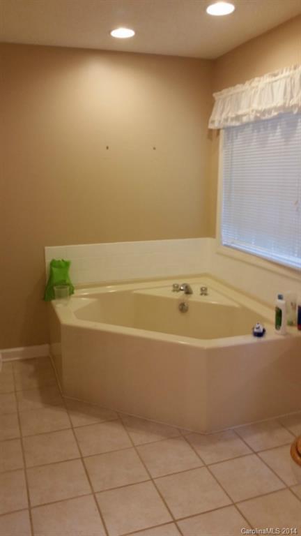 7003 Providence Road South Waxhaw, NC 28173 - Photo 15 of 20 a bathroom with a bathtub and a shower
