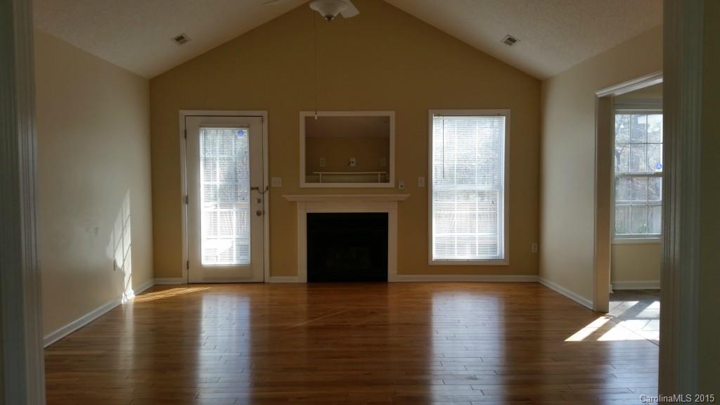 7003 Providence Road South Waxhaw, NC 28173 - Photo 3 of 20 a view of a livingroom with wooden floor and a fireplace
