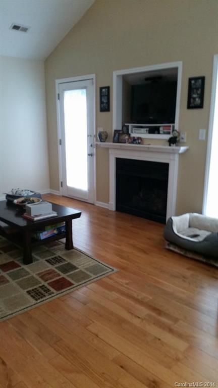 7003 Providence Road South Waxhaw, NC 28173 - Photo 4 of 20 a living room with furniture a flat screen tv and a fireplace