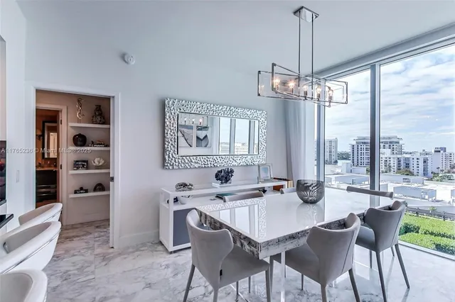 a dining room with furniture a chandelier and window
