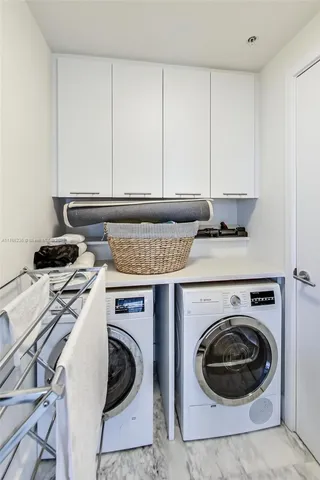 a utility room with sink dryer and washer