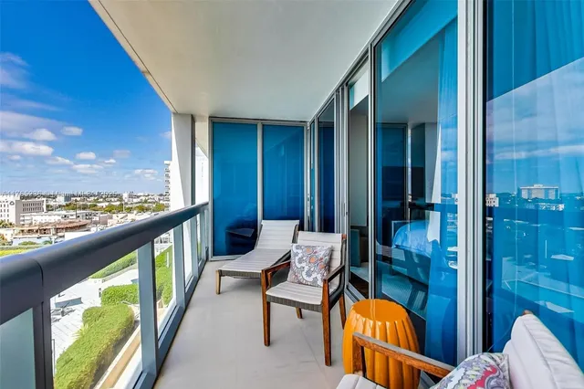 a balcony with chairs and a table