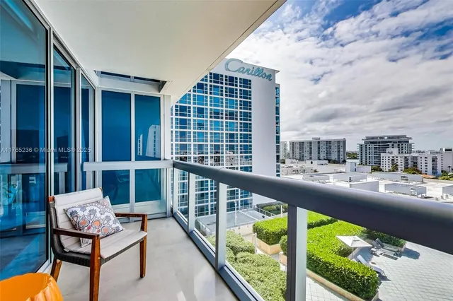 a balcony with table and chairs