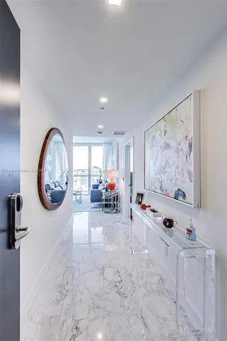 a view of a livingroom with furniture cabinet mirror and window