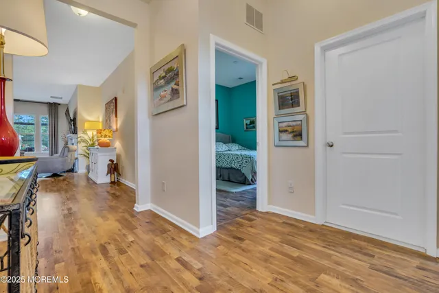 a view of a dining room with furniture a chandelier and wooden floor