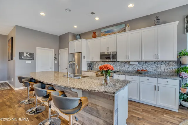 a living room with dining table and a chandelier