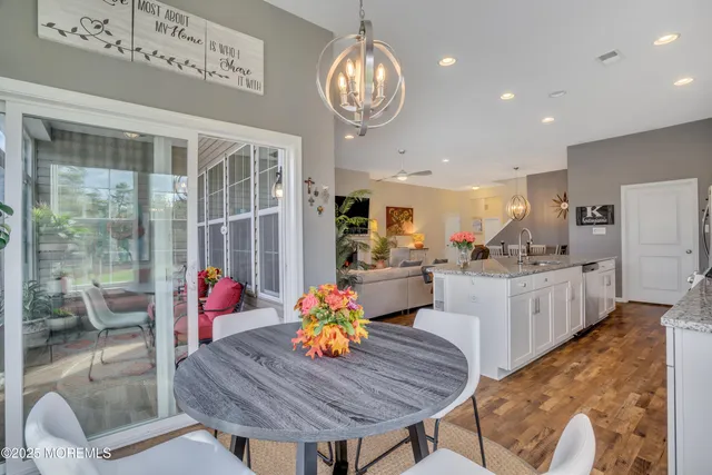 a kitchen with stainless steel appliances granite countertop a sink and a refrigerator