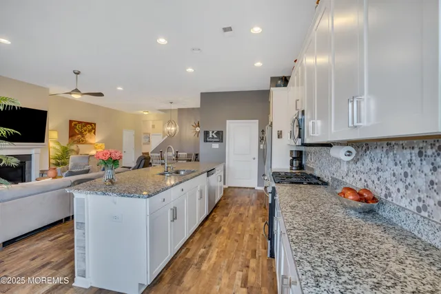 a living room with patio furniture and a potted plant