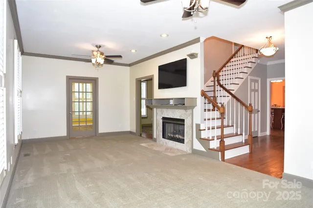 a living room with furniture a chandelier and a potted plant