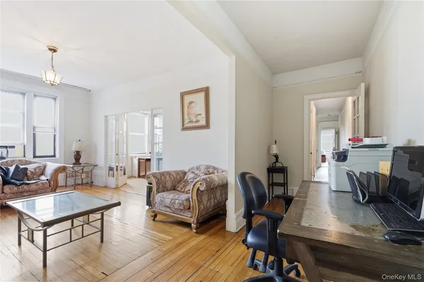a living room with furniture a window and a chandelier