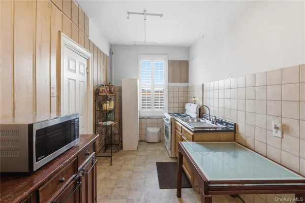 a living room with furniture stove and a window