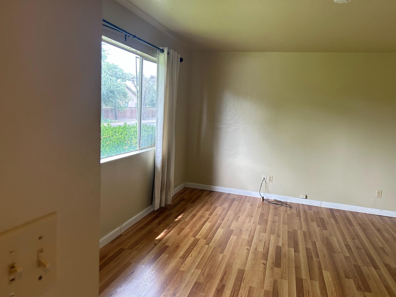 413 Shakeley Lane Ione, CA 95640 - Photo 2 of 11 an empty room with wooden floor and windows