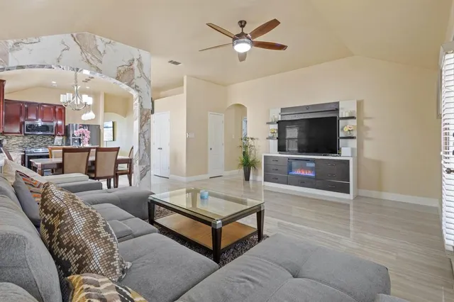 a living room with furniture and a flat screen tv