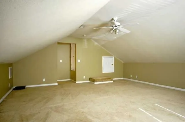 an empty room with a ceiling fan