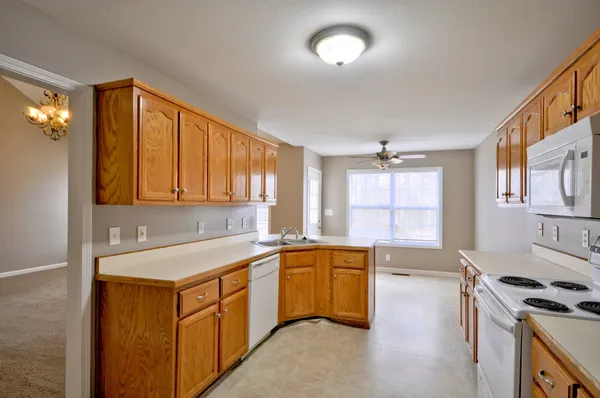 a kitchen with a sink stove and cabinets