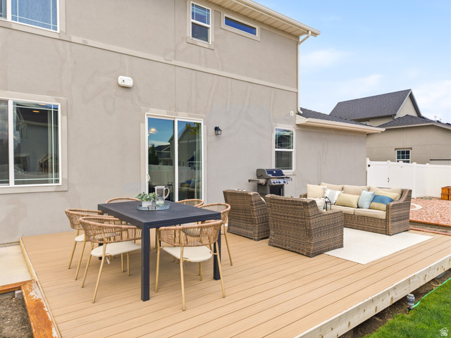 834 West 1050th Street South Springville, UT 84663 - Photo 21 of 26 Expansive outdoor deck featuring wood-finish decking, a sliding glass door, and a stucco exterior