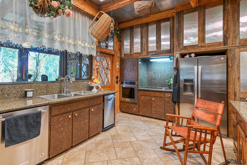 375-397 Southeast County Road Starke, FL 32091 - Photo 16 of 75 a kitchen with stainless steel appliances granite countertop a sink and cabinets