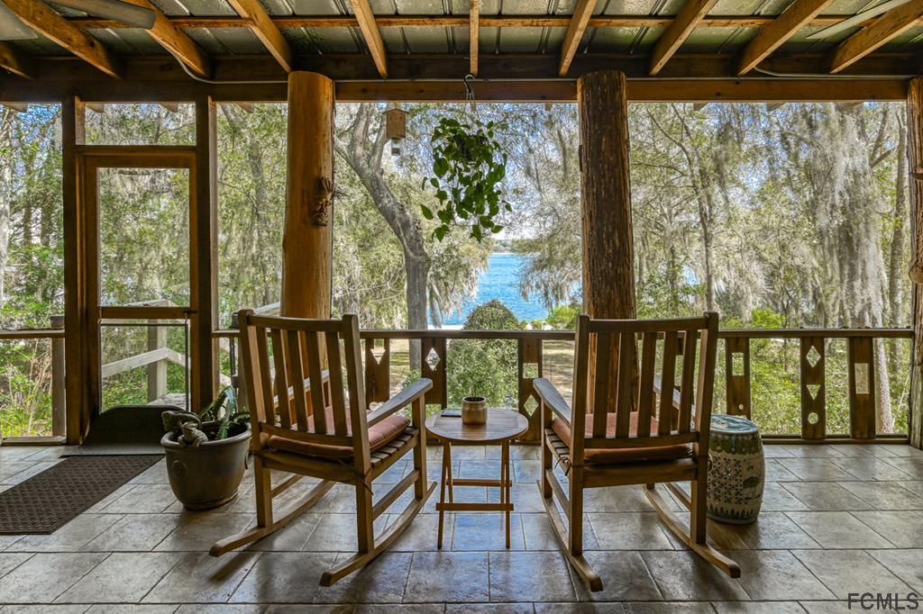 375-397 Southeast County Road Starke, FL 32091 - Photo 20 of 75 Screened Veranda with Tree Trunk Supports