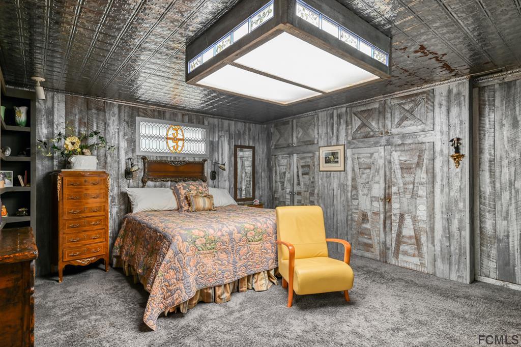 375-397 Southeast County Road Starke, FL 32091 - Photo 37 of 75 a bedroom with a bed and a chandelier