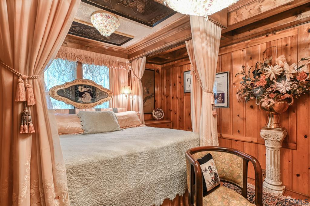 375-397 Southeast County Road Starke, FL 32091 - Photo 45 of 75 a bedroom with a bed and a chandelier