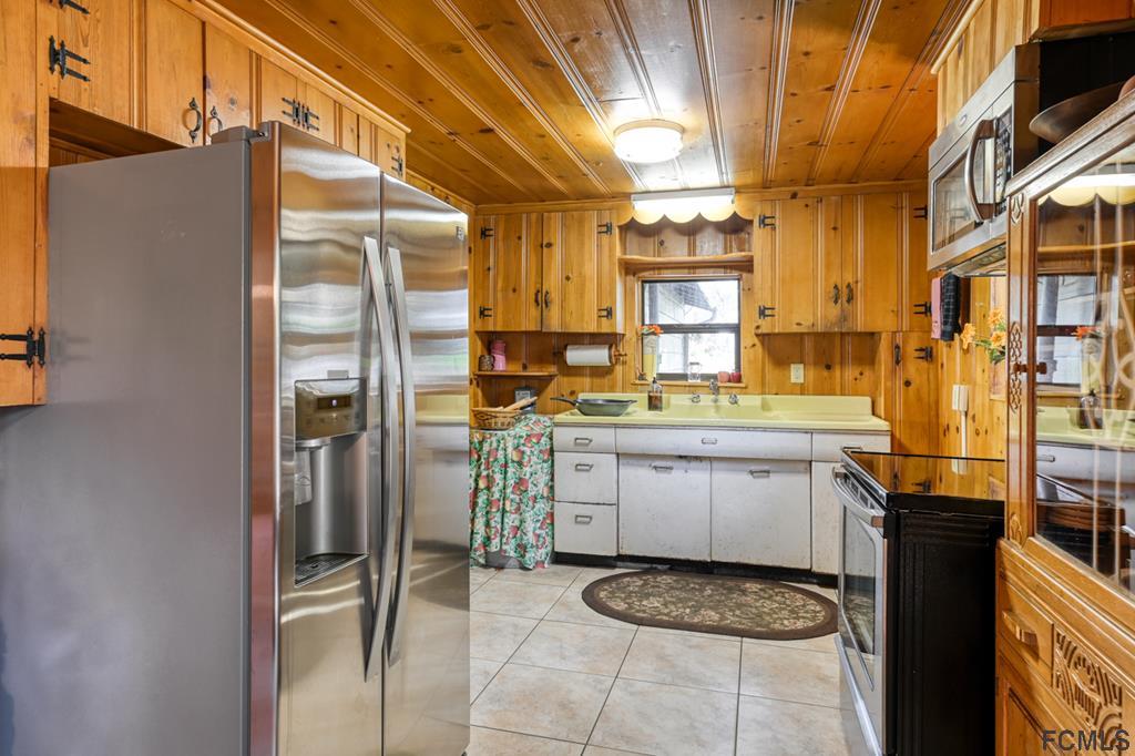 375-397 Southeast County Road Starke, FL 32091 - Photo 58 of 75 a kitchen with a refrigerator and a stove
