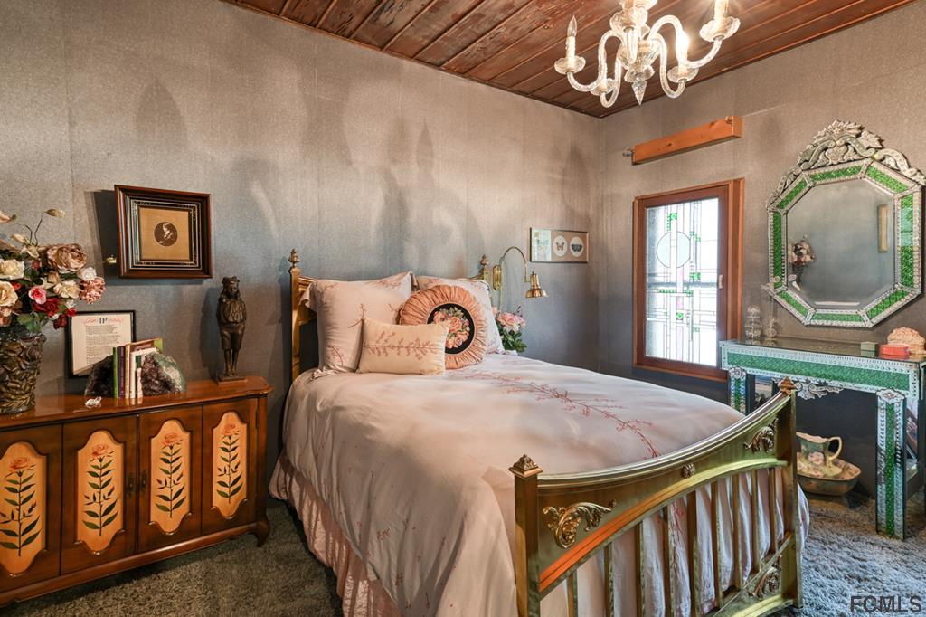 375-397 Southeast County Road Starke, FL 32091 - Photo 59 of 75 a bedroom with bed and a chandelier