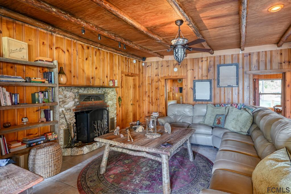 375-397 Southeast County Road Starke, FL 32091 - Photo 61 of 75 a living room with furniture a fireplace and a book shelf