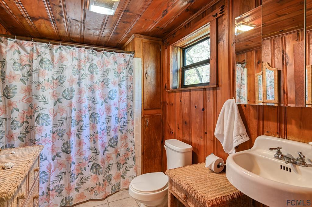375-397 Southeast County Road Starke, FL 32091 - Photo 69 of 75 a bathroom with a sink a toilet and shower curtain
