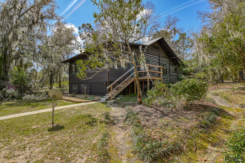 375-397 Southeast County Road Starke, FL 32091 - Photo 72 of 75 a house with trees in front of it