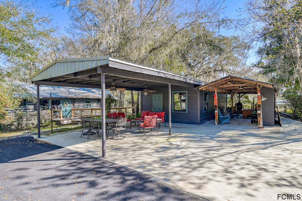 375-397 Southeast County Road Starke, FL 32091 - Photo 73 of 75 a view of a chair and table in the patio and a fire pit