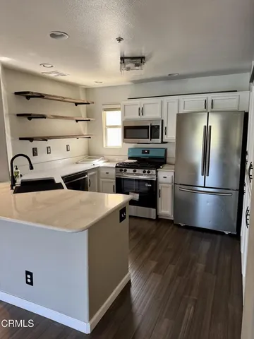 a stove top oven sitting inside of a kitchen