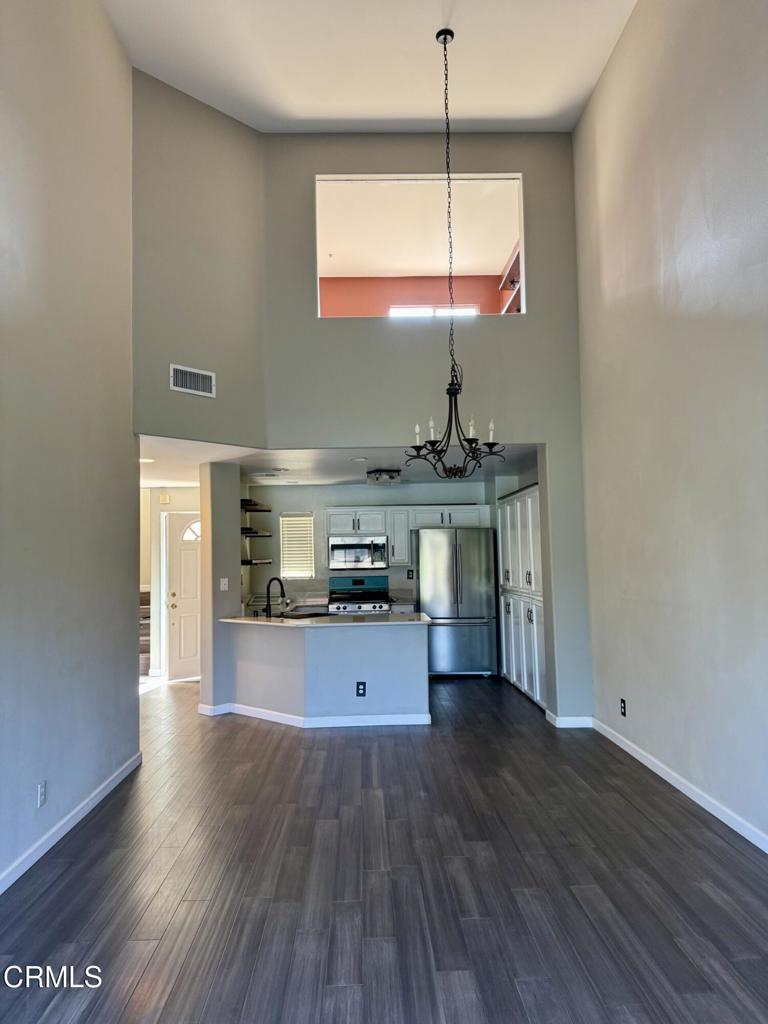 2742 Borchard Road Newbury Park, CA 91320 - Photo 6 of 51 a kitchen with stainless steel appliances granite countertop a stove and wooden floor