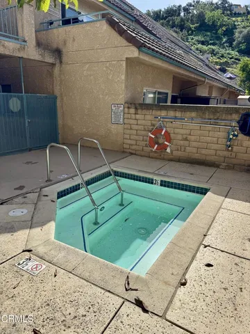 a view of a hallway with wooden floor and workspace