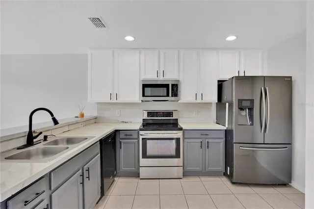 a kitchen with a sink stove and refrigerator