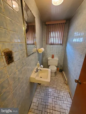 a bathroom with a sink toilet and mirror
