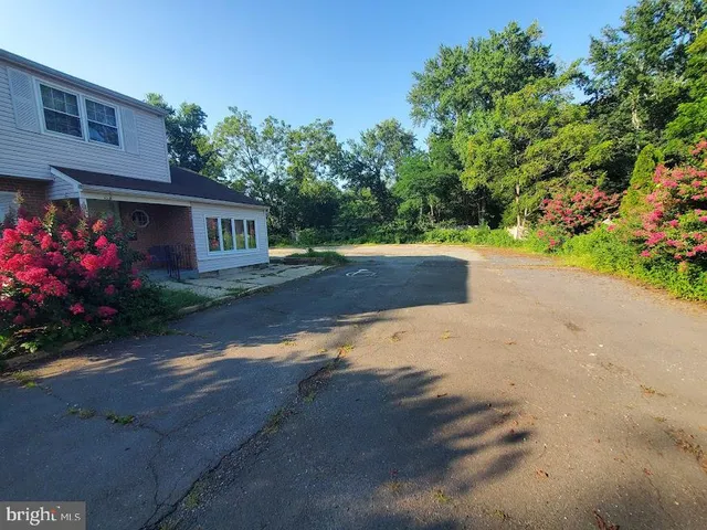 a wooden bench sitting in front of a house