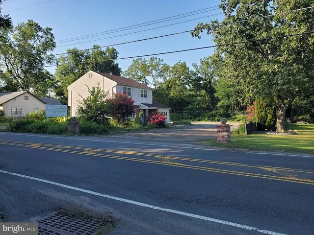 a view of street along with house and trees