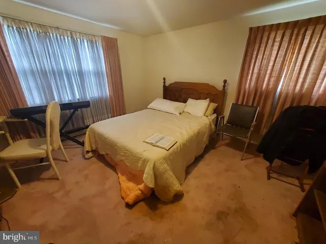 a bed sitting in a room next to a window