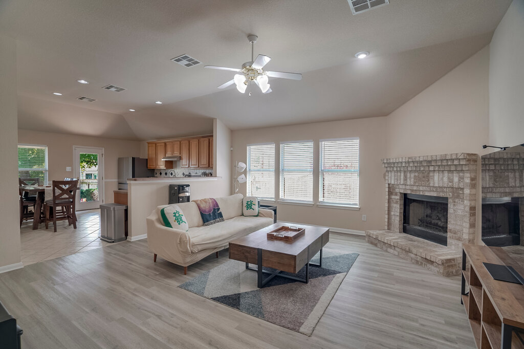 2724 Kickapoo Cavern Drive Pflugerville, TX 78660 - Photo 6 of 24 Step into this luminous living space, featuring a cozy fireplace and contemporary flooring.