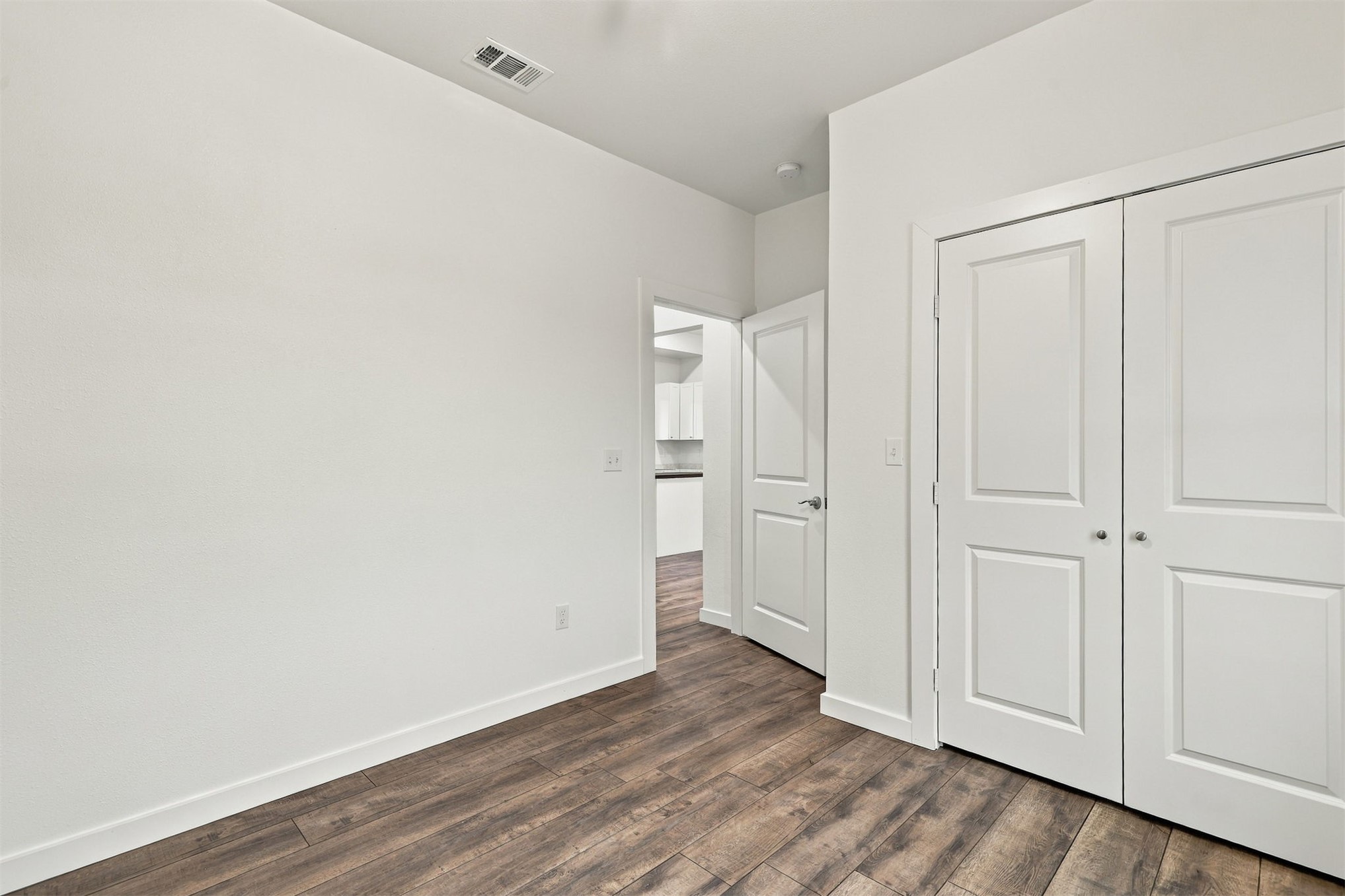 21 Redbird Lane Colbert, OK 74733 - Photo 10 of 27 Wood-finish flooring with crisp white walls and trim