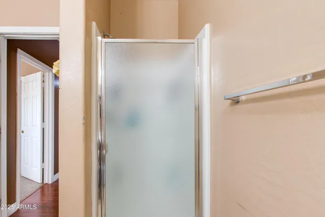 a bathroom with a glass shower door
