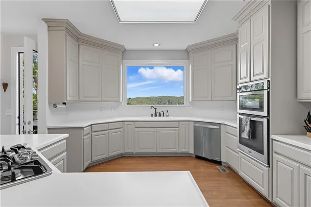a kitchen with a wooden table and chairs