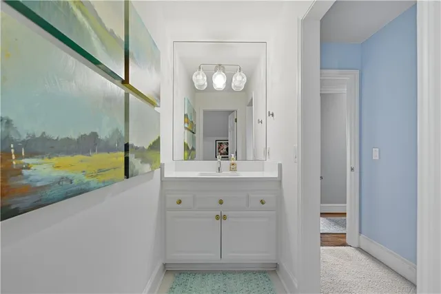 a bedroom with a white bed and a chandelier