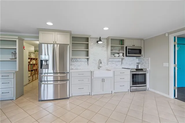 a view of a house with a yard and potted plants