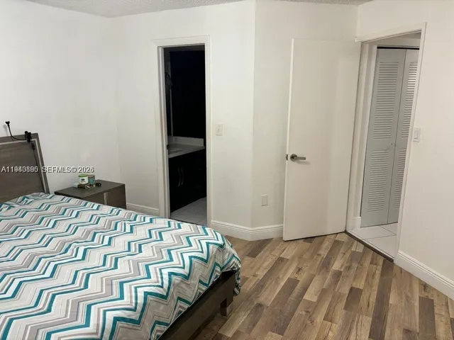 a bed sitting in a bedroom next to a bathroom