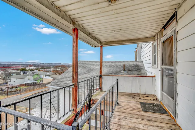 a view of a balcony with wooden floor